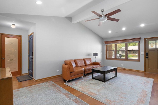 living room with vaulted ceiling with beams, ceiling fan, and light hardwood / wood-style flooring