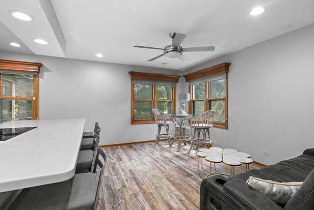 interior space featuring ceiling fan, wood-type flooring, and a healthy amount of sunlight