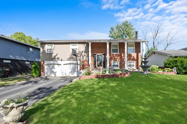 split foyer home with a front yard and a garage