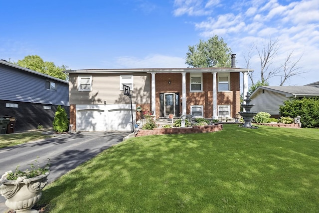 split foyer home with a garage and a front yard