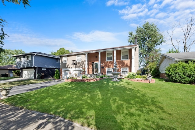 raised ranch featuring a front lawn and a garage