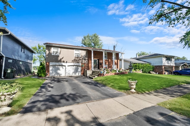 bi-level home featuring a front yard and a garage