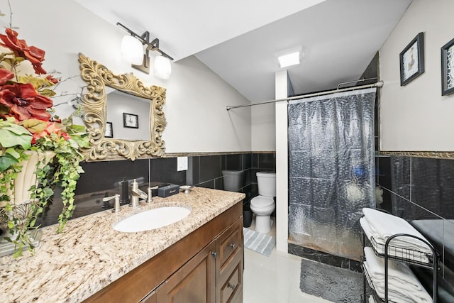 bathroom with tile walls, vanity, a shower with curtain, tile patterned floors, and toilet