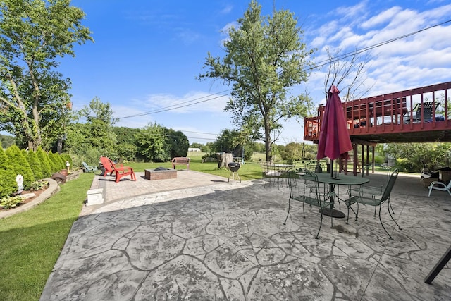 view of patio with a deck and an outdoor fire pit