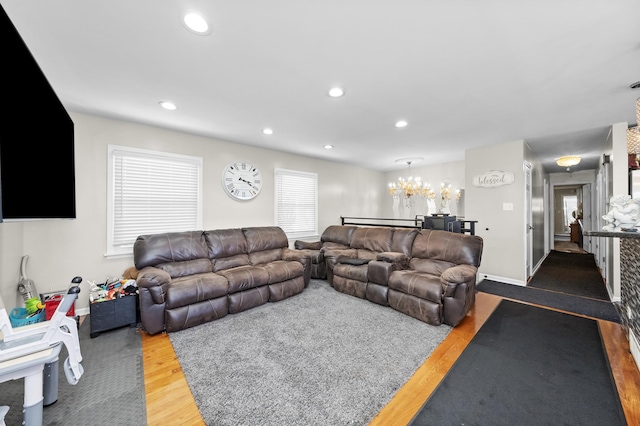 living room with wood-type flooring and a chandelier