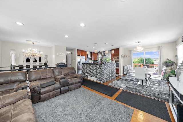 living room featuring wood-type flooring and a notable chandelier