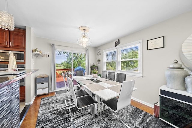 dining room featuring dark wood-type flooring and a chandelier