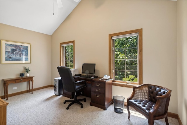 home office with baseboards, high vaulted ceiling, a ceiling fan, and light colored carpet