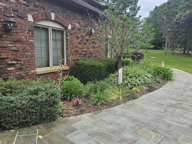 view of side of property featuring brick siding