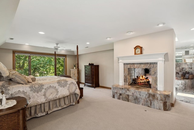 bedroom with recessed lighting, light carpet, a fireplace, visible vents, and baseboards