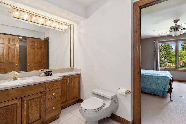 bathroom with ensuite bathroom, toilet, a ceiling fan, vanity, and tile patterned floors