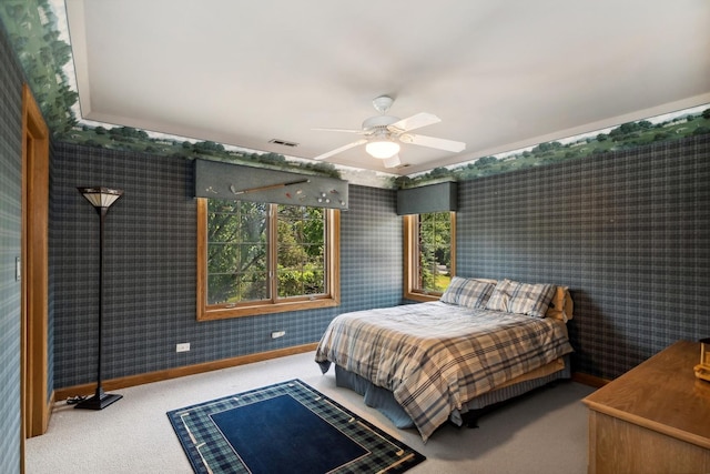 bedroom with wallpapered walls, baseboards, visible vents, a ceiling fan, and carpet