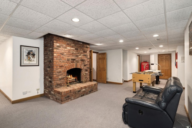 carpeted living area featuring recessed lighting, a fireplace, a paneled ceiling, and baseboards