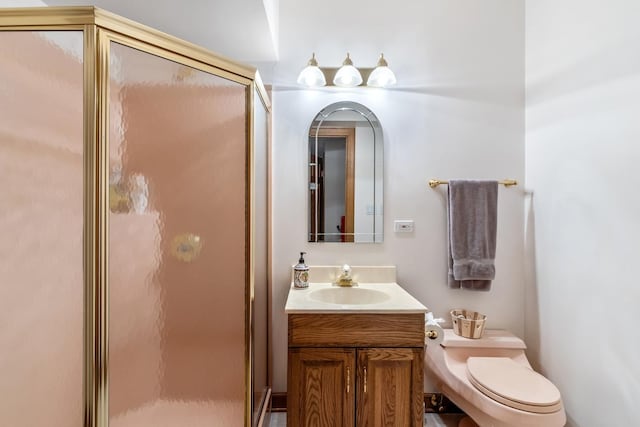 full bath with toilet, a shower stall, and vanity