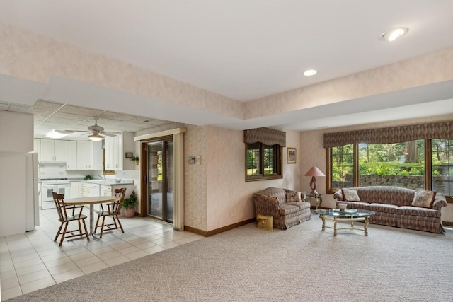 living area with light tile patterned floors, recessed lighting, light carpet, baseboards, and wallpapered walls