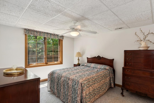 bedroom with visible vents, ceiling fan, light carpet, and a drop ceiling