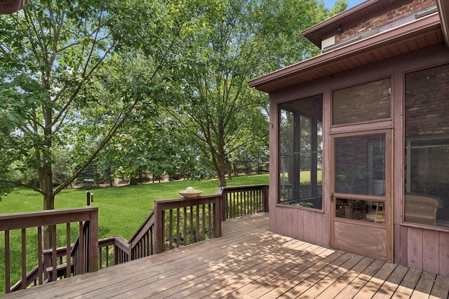 wooden terrace with a sunroom and a yard