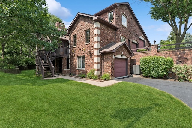 view of front of property with driveway, stairway, cooling unit, a front yard, and brick siding