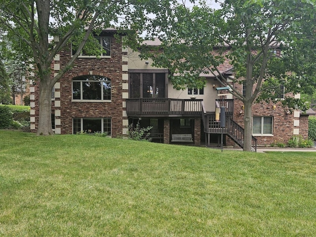 back of property featuring a deck, stairway, and a lawn