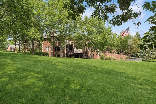 view of yard with a wooden deck and stairs