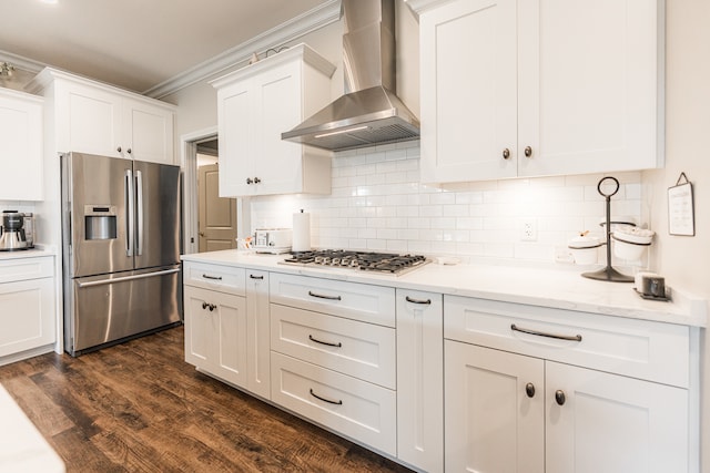 kitchen with crown molding, stainless steel appliances, dark hardwood / wood-style floors, decorative backsplash, and wall chimney range hood