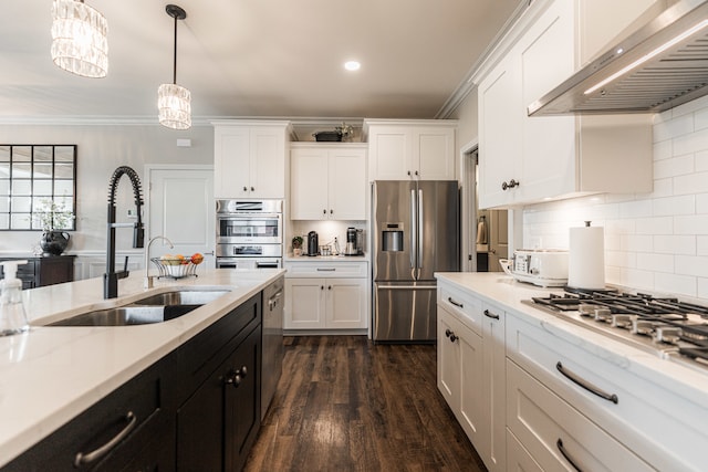 kitchen featuring appliances with stainless steel finishes, dark wood-type flooring, ornamental molding, and wall chimney range hood