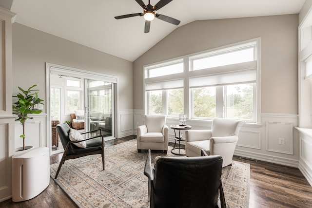 living room with ceiling fan, dark hardwood / wood-style flooring, and vaulted ceiling