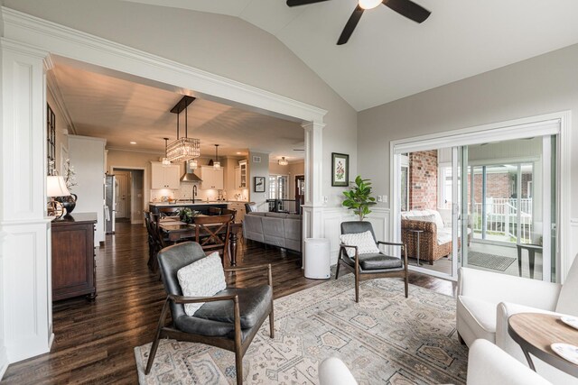 living room with dark hardwood / wood-style flooring, ceiling fan, vaulted ceiling, decorative columns, and sink