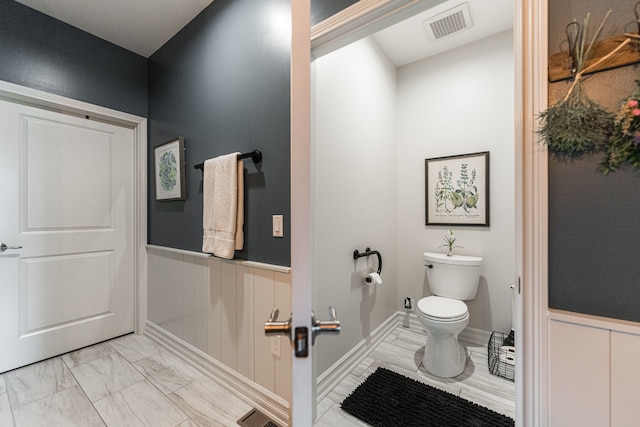 bathroom featuring toilet and tile patterned floors