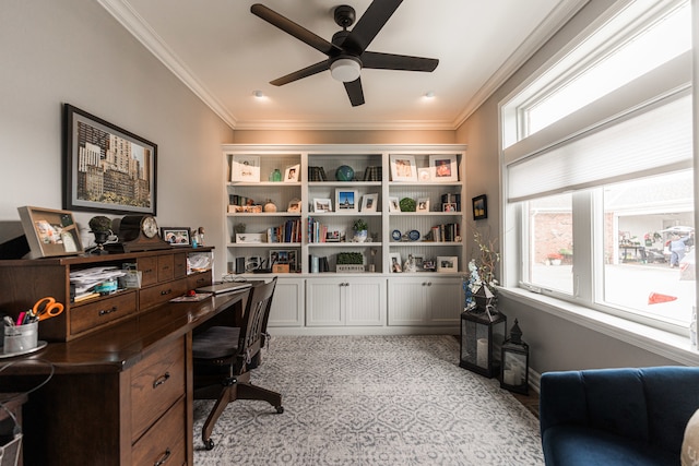 carpeted office with ceiling fan, a wealth of natural light, and ornamental molding