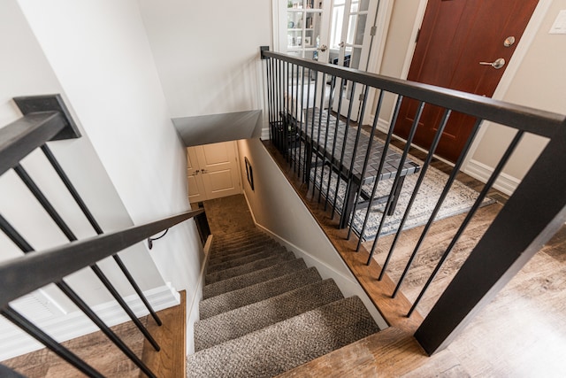 stairs with hardwood / wood-style floors