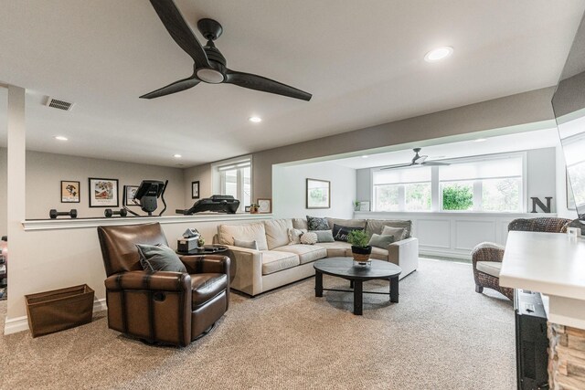 carpeted living room with plenty of natural light and ceiling fan