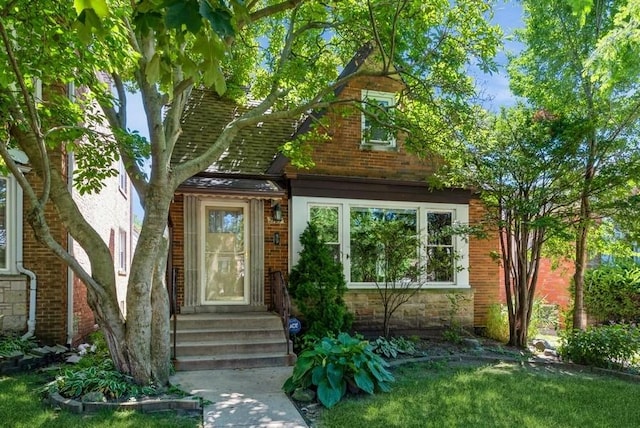 property entrance featuring stone siding and brick siding