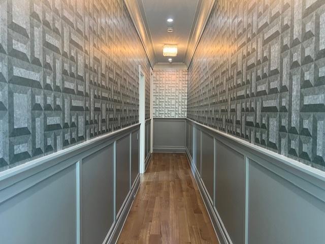 hall featuring dark hardwood / wood-style flooring and crown molding