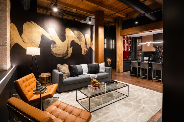 home theater with hardwood / wood-style flooring, beam ceiling, and wood ceiling