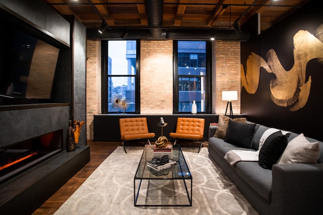 cinema room featuring wood ceiling, brick wall, and dark hardwood / wood-style flooring