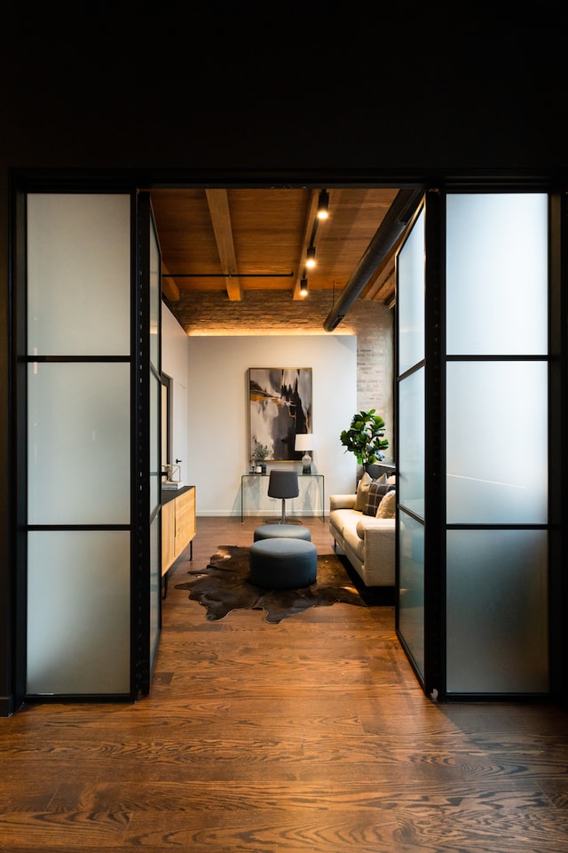 kitchen with dark wood-type flooring, track lighting, beam ceiling, and wood ceiling