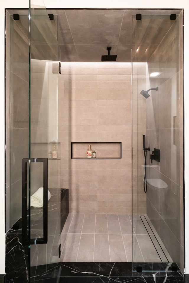 bathroom featuring a shower with door