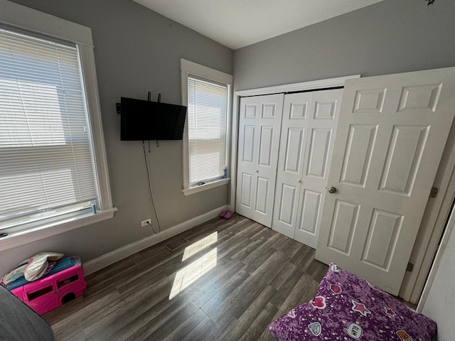 bedroom with a closet and dark hardwood / wood-style flooring