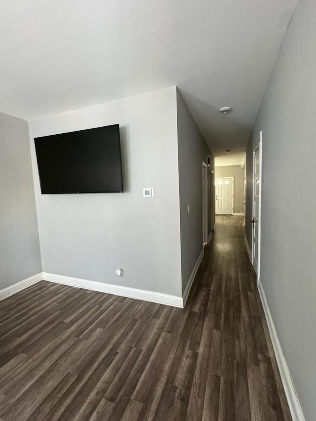 corridor featuring dark hardwood / wood-style flooring