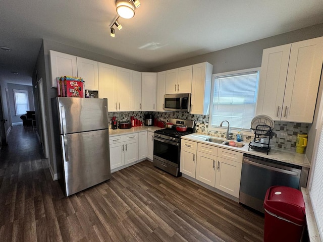 kitchen featuring stainless steel appliances, white cabinets, and sink