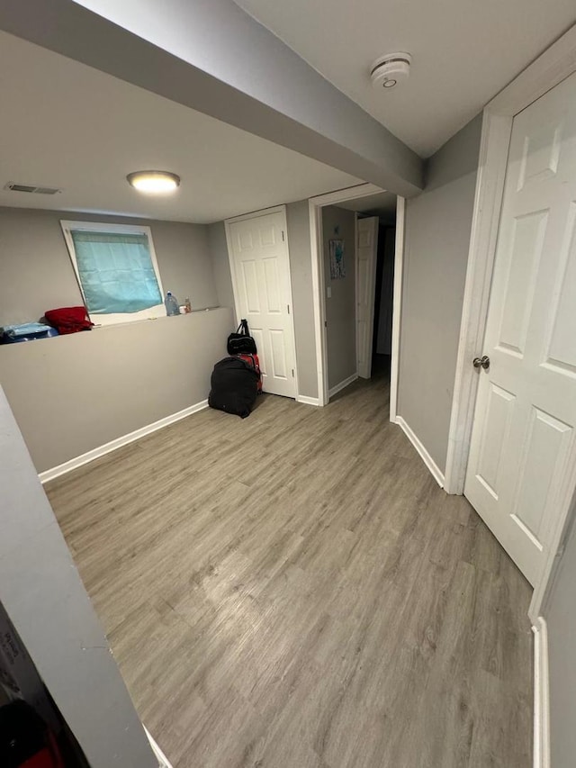 basement with hardwood / wood-style floors