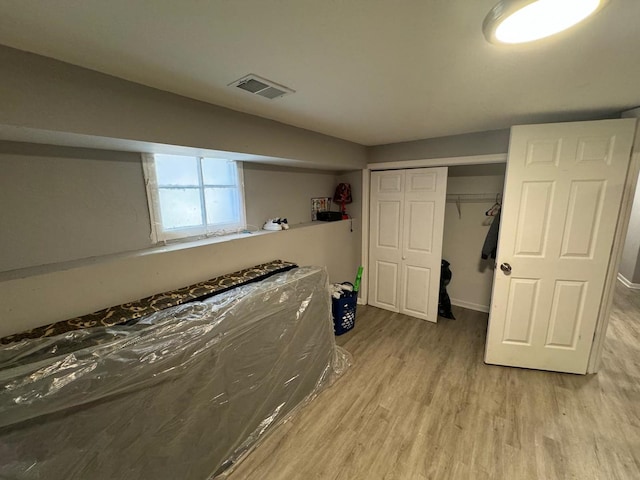 unfurnished bedroom featuring a closet and light wood-type flooring