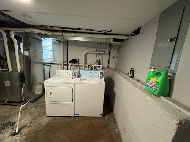 washroom with electric panel, separate washer and dryer, and heating unit