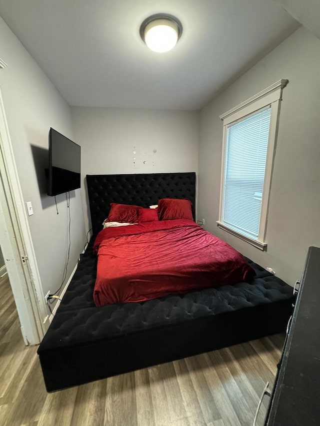 bedroom with hardwood / wood-style flooring