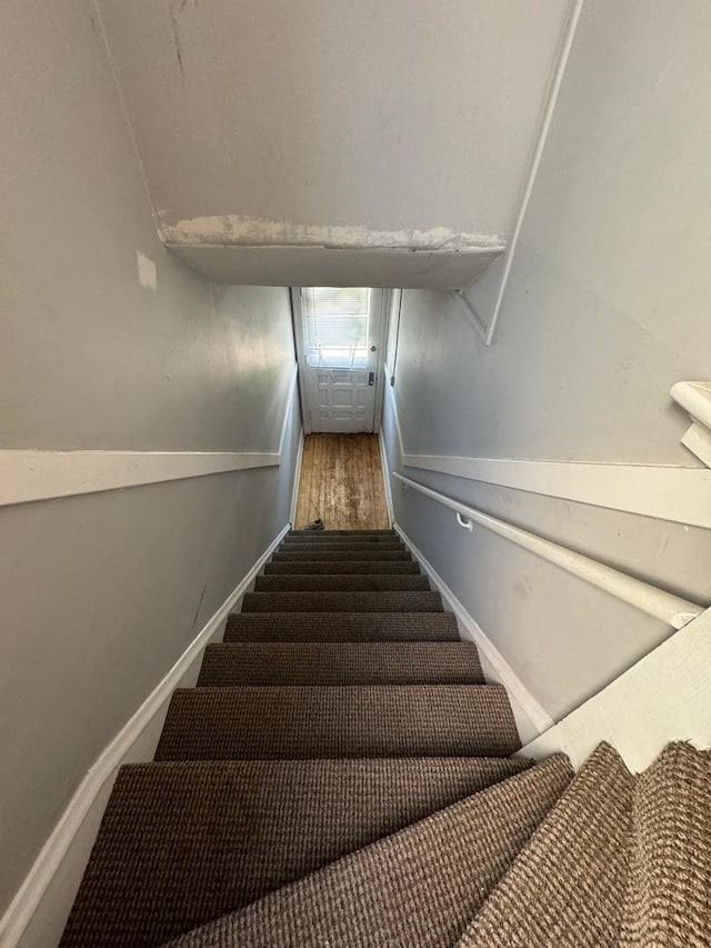 staircase featuring hardwood / wood-style floors