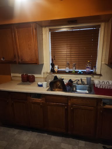 kitchen with sink and dark tile patterned floors