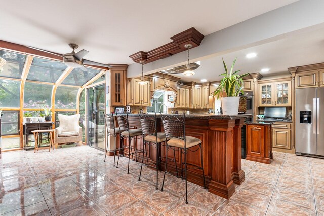 kitchen featuring a wealth of natural light, ceiling fan, stainless steel fridge with ice dispenser, and light tile patterned floors