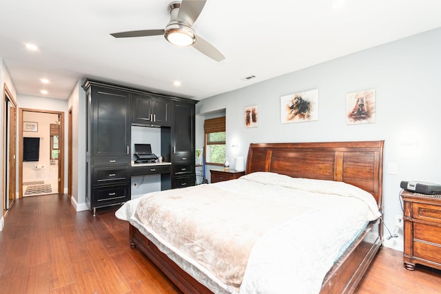 bedroom featuring ceiling fan, dark wood-type flooring, and ensuite bathroom