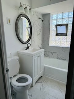 full bathroom with vanity, tiled shower / bath combo, and toilet